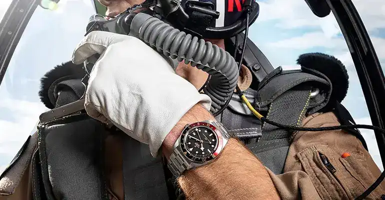 Close-up of a pilot wearing a Tudor watch in an aircraft cockpit - Washington Watches