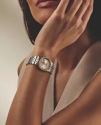 Woman wearing a Tudor watch with a silver bracelet - Washington Watches