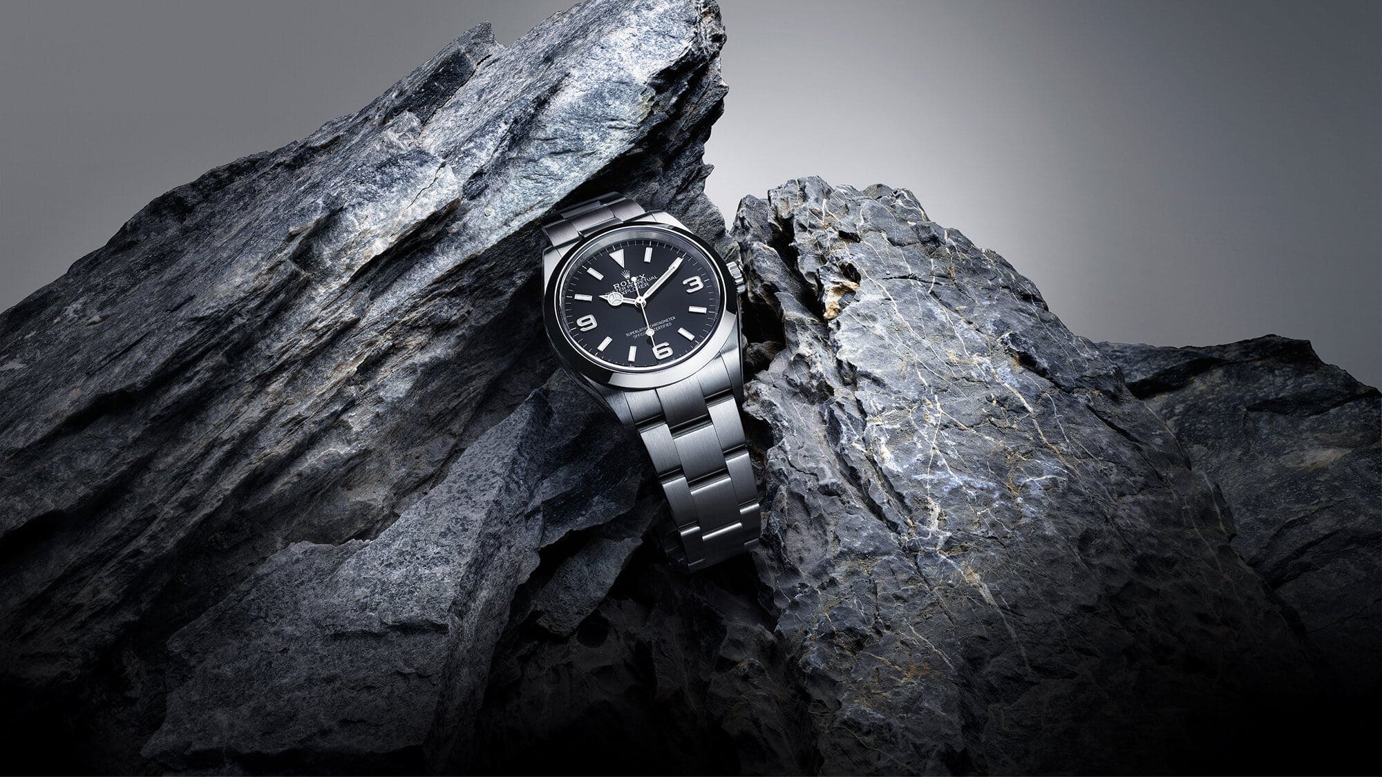 Rolex Explorer watch with black dial set among rocks - Swee Cheong Watch